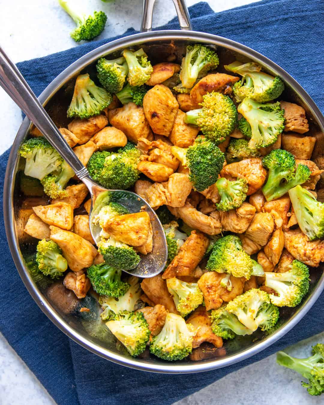 chicken in a skillet with broccoli