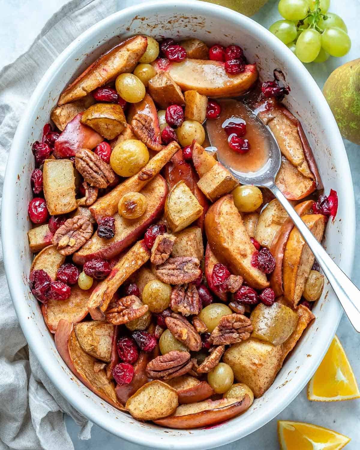 baked fruits in a dish with spoon in it.