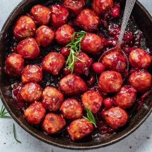 image of some cranberry sauce chicken meatballs in a black skillet
