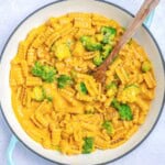 a dish with vegan mac and cheese served with broccoli.