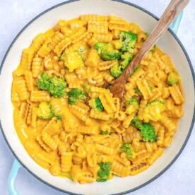 a dish with vegan mac and cheese served with broccoli.