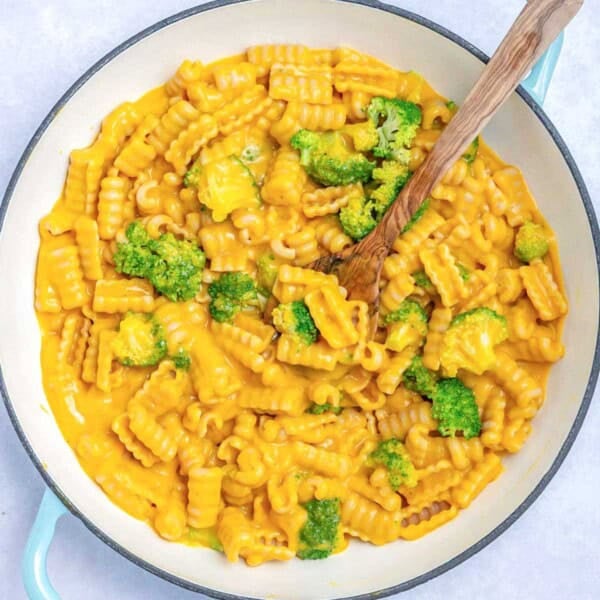 a dish with vegan mac and cheese served with broccoli.
