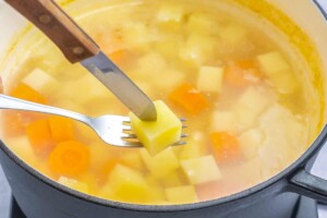 boiled potatoes and carrots in a pot.