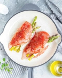 chicken breast uncooked placed on a skillet.