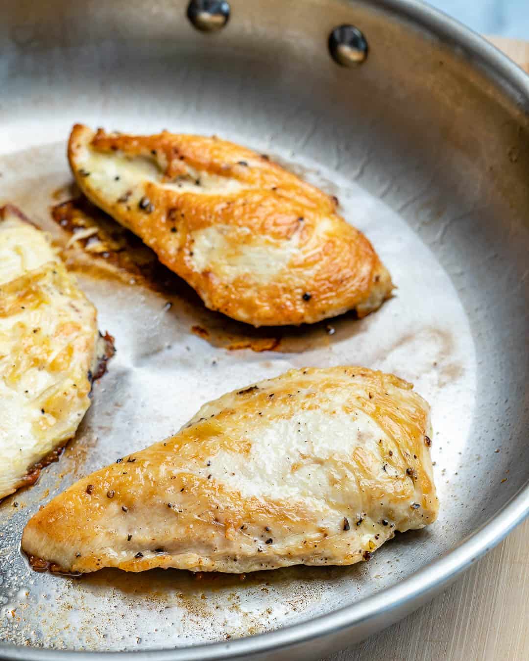 3 cooked chicken breasts on a pan