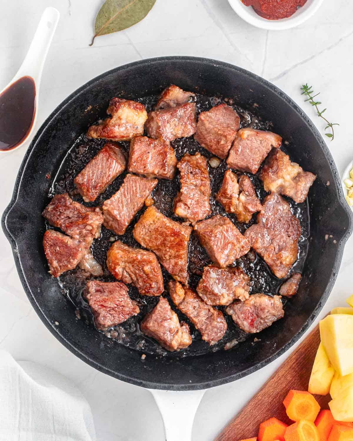 cooked beef chunks in a skillet.