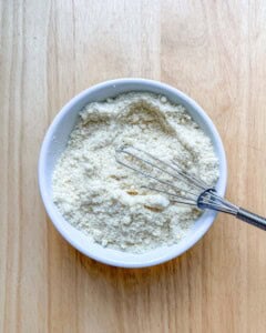 dry ingredients added to a bowl for pancakes.