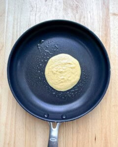 Pancakes added to the pan to be cooked.