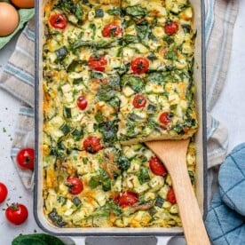 A portion of baked eggs and veggies on a spatula.