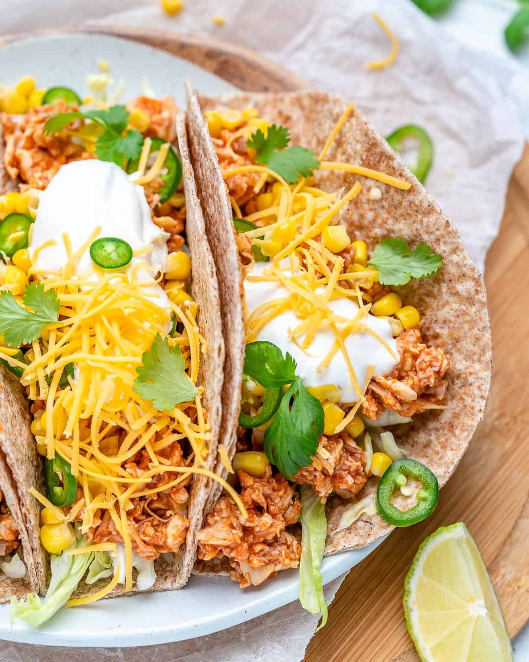 buffalo chicken tacos on plate with lime