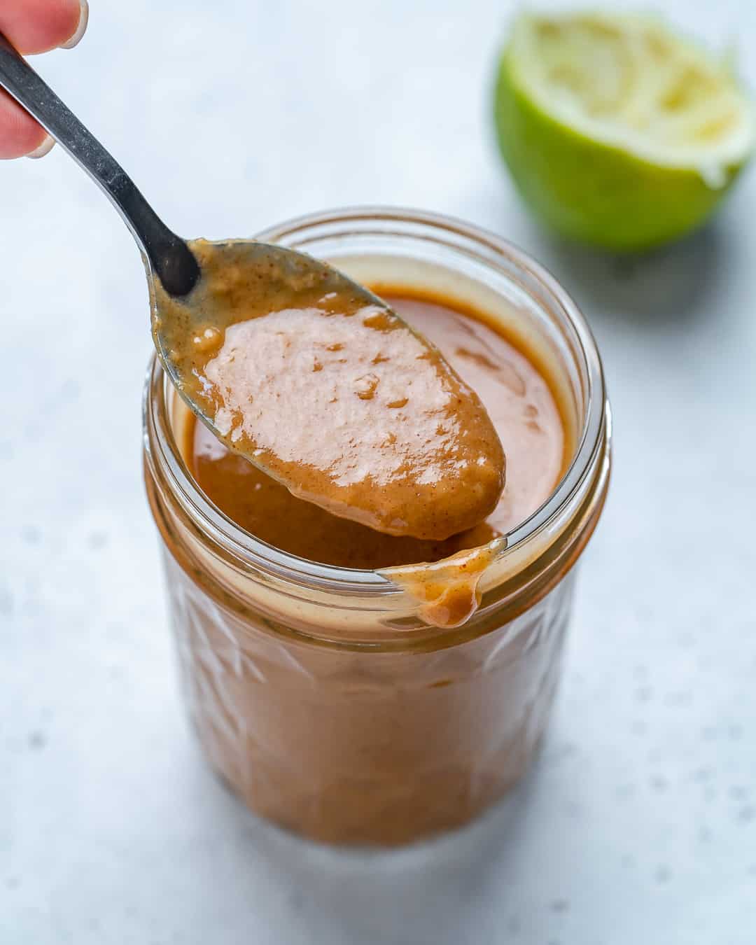 Spoonful of Healthy Thai Peanut Dressing in jar