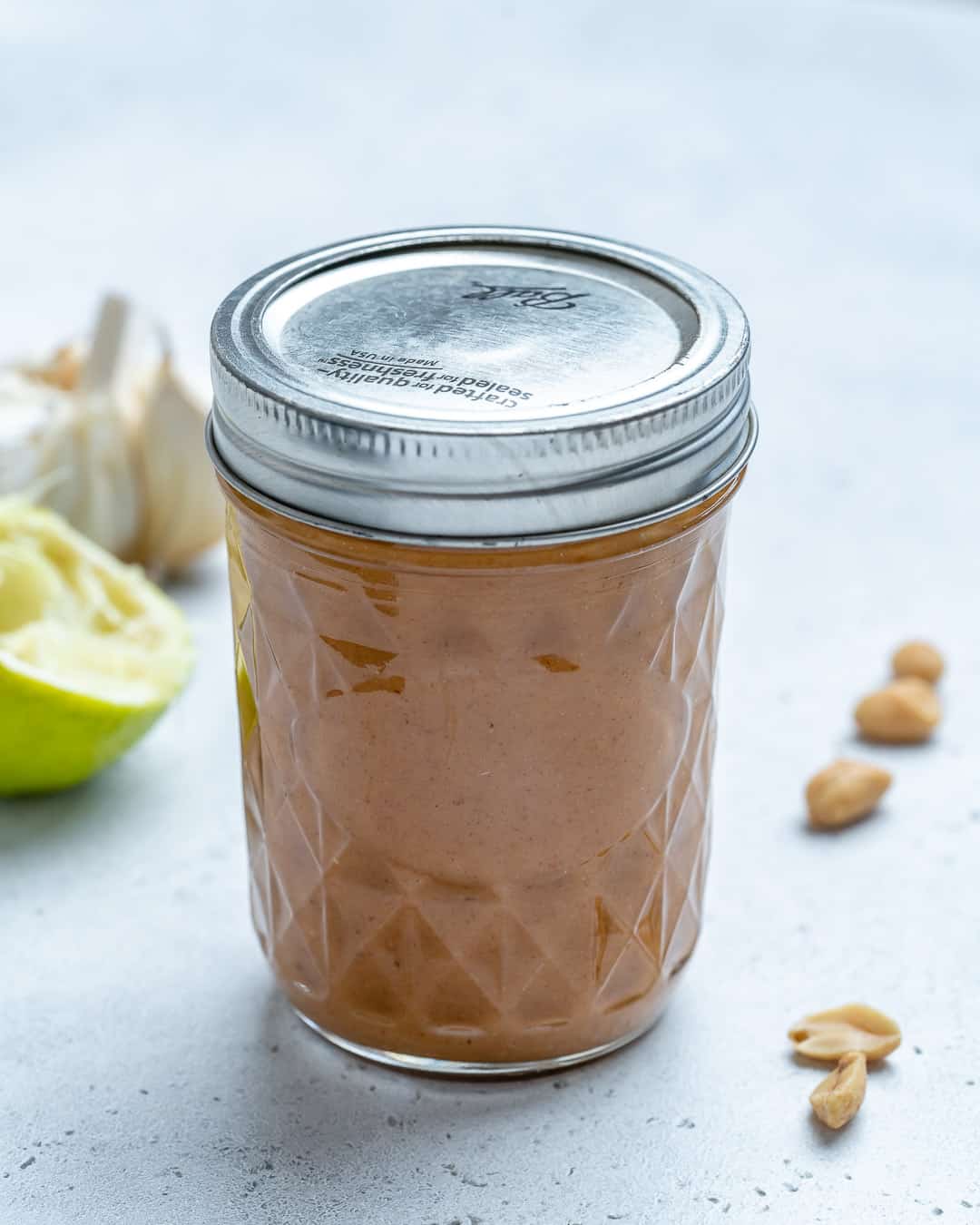 Jar of Healthy Thai Peanut Dressing on counter