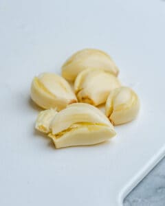 crushed garlic on cutting board