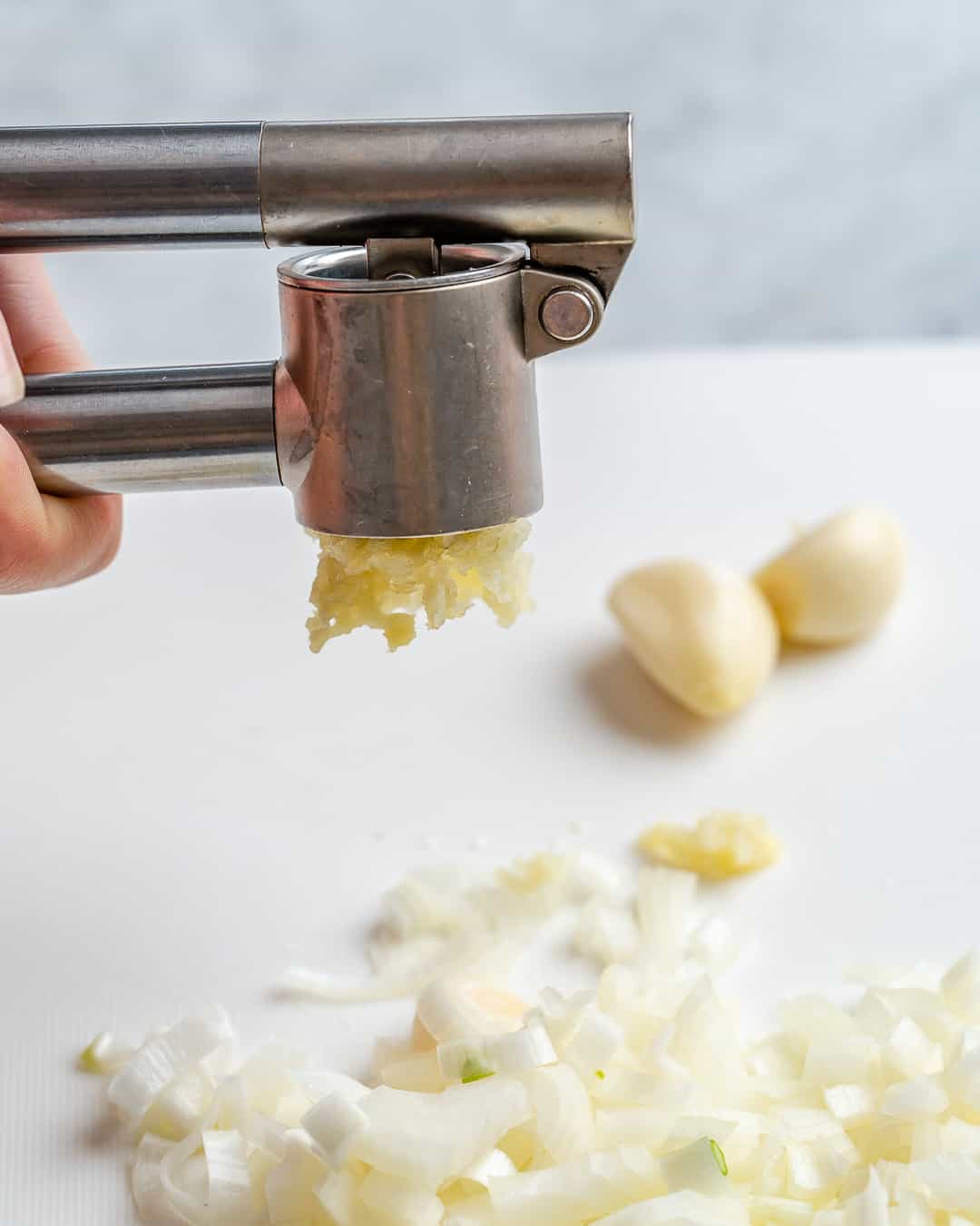 Press garlic or mince.