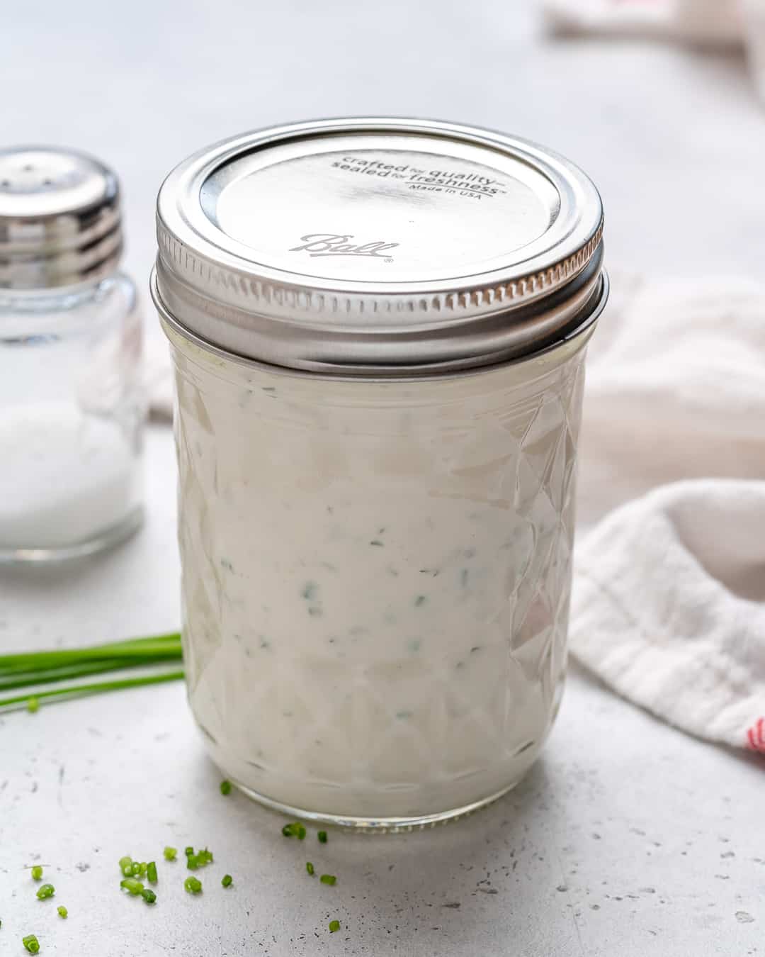 Homemade Ranch Dressing in a jar on the counter.