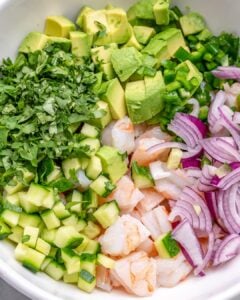 Shrimp ceviche ingredients in a bowl before mixing.