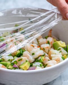 covered ceviche in a bowl with plastic wrap and place in fridge