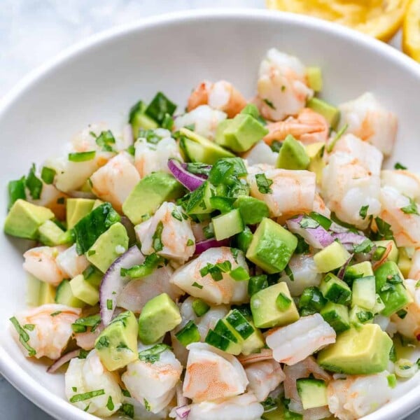 A round plate filled with shrimp ceviche.