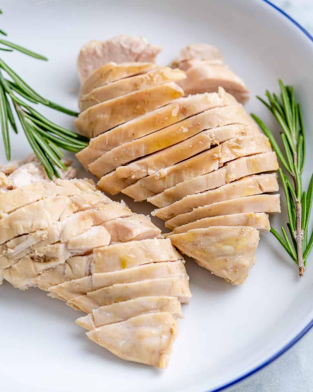 Sliced poached chicken on plate