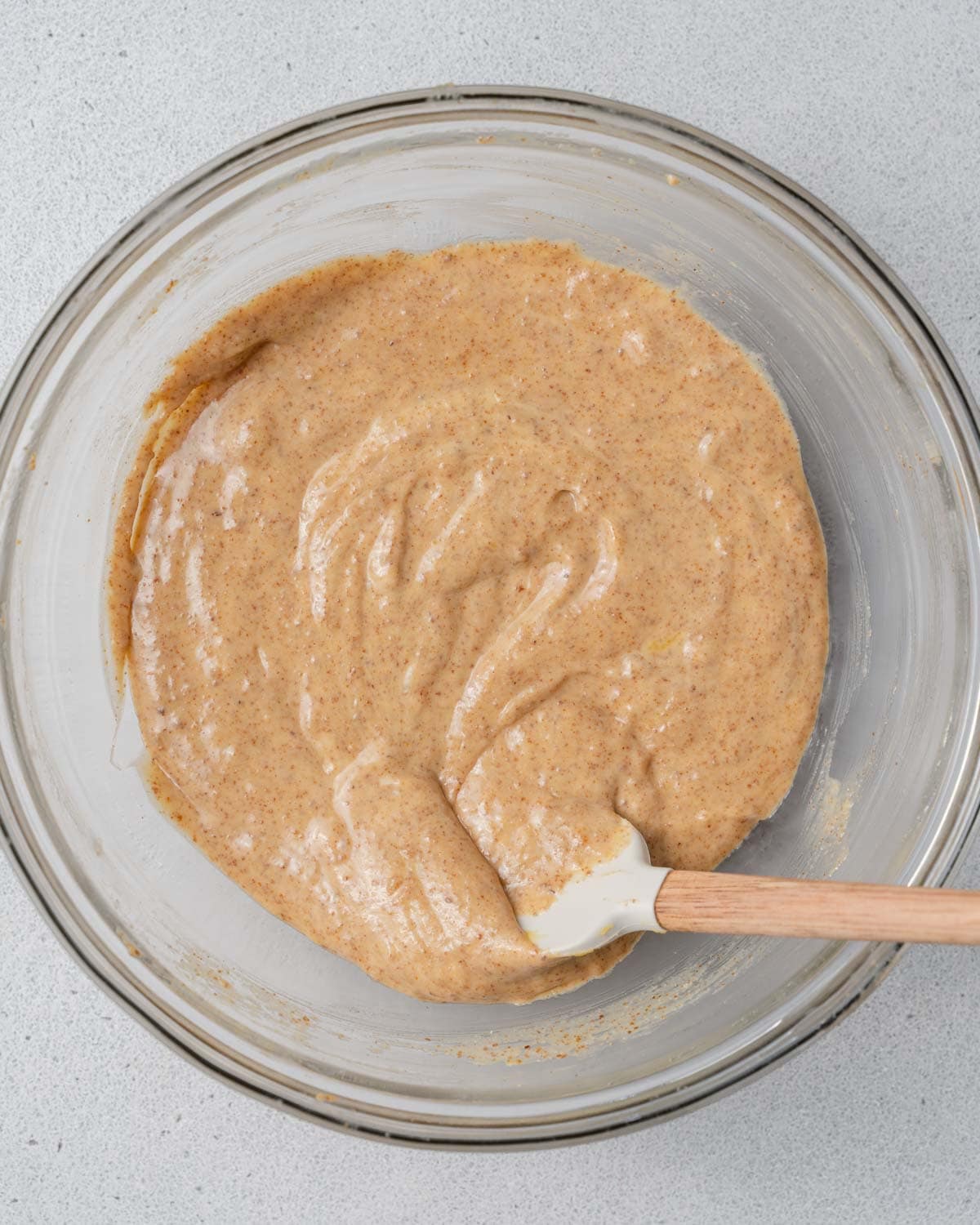 a bowl with almond butter, egg, and pumpkin, mixed until smooth.