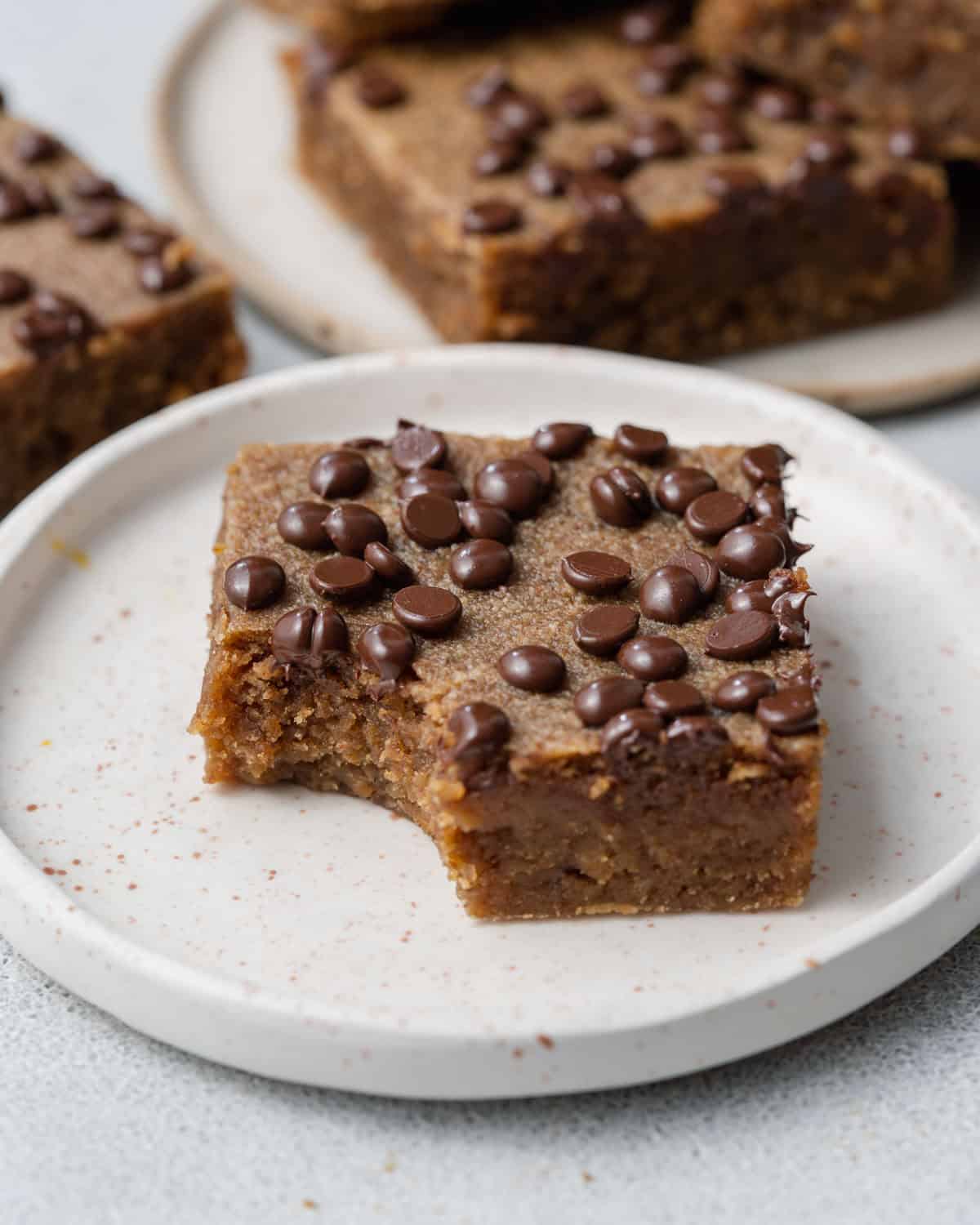 s pumpkin square bar on a plate with a bite taken off it.