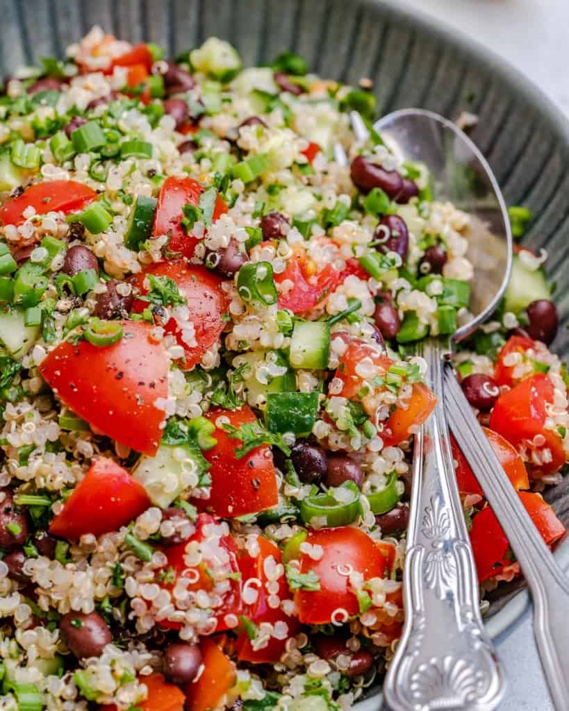 side view of mixed tabbouleh salad on plate with spoon visible in the tabbouleh