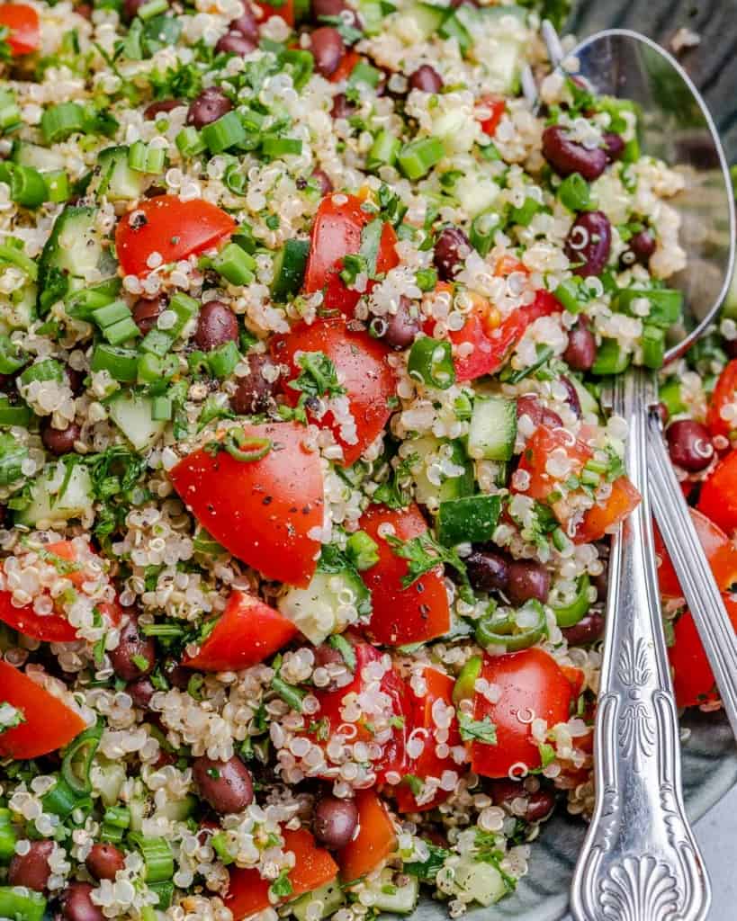 Close up view of tabbouleh on a plate with spoon in dish  