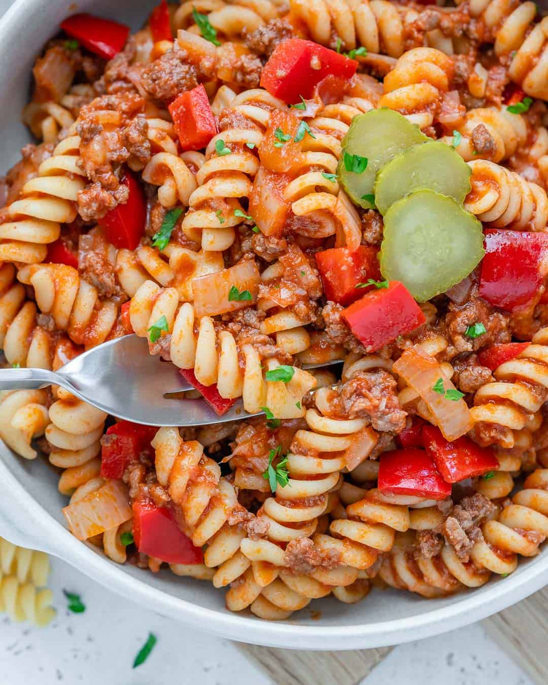 beef pasta in a white bowl with fork in it