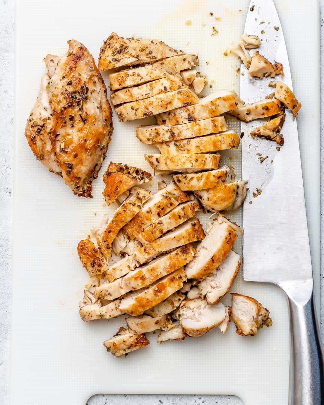 sliced up cooked chicken on cutting board for the salad 