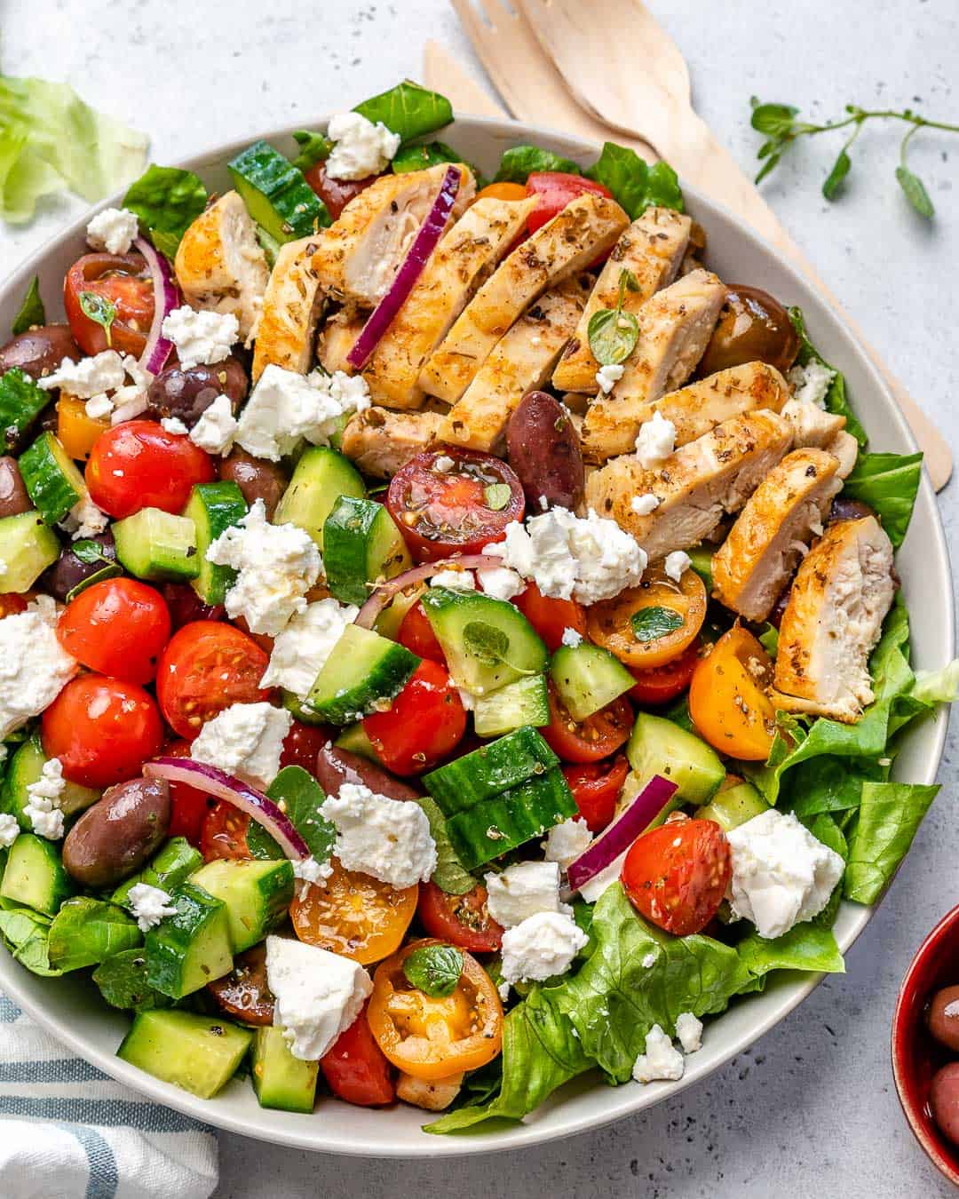 grilled chicken slices on salad in a white bowl