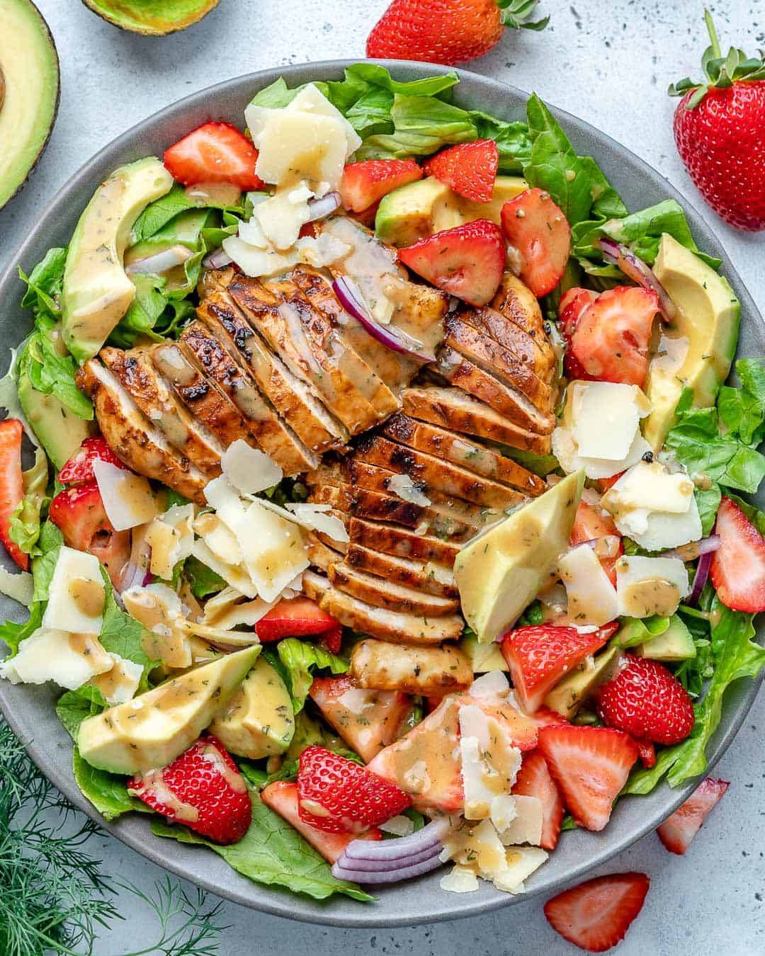 top view of healthy chicken salad with strawberries in a bowl