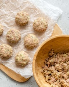 uncooked patties on baking sheet, and a bowl with some more tuna mix