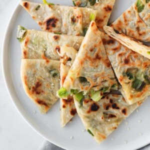 top view of cut up scallion pancake on a plate