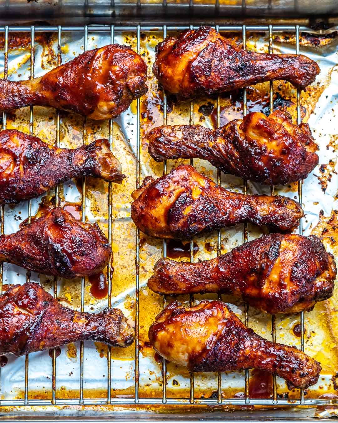 side shot of baked drumsticks on a rack