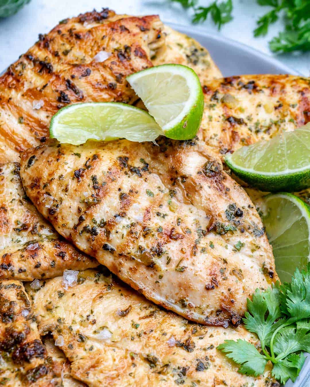 close up view of grilled chicken breasts on a plate 