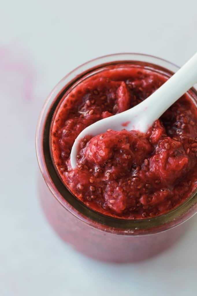 top view of chia strawberry jam in a jar with spoon in jar 