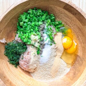 ingredients for the chicken fritters placed in a bowl.