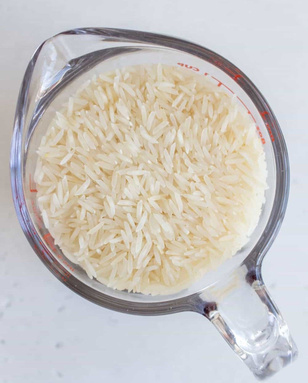 raw basmati rice in a measuring cup
