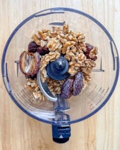 dates and walnuts placed in a food processor.
