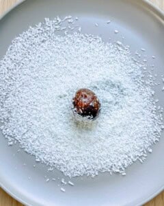 rolling date ball in shredded coconut.