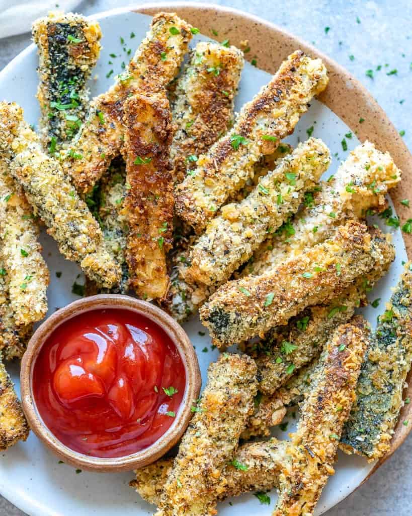 close up view of zucchini fries on a plate 