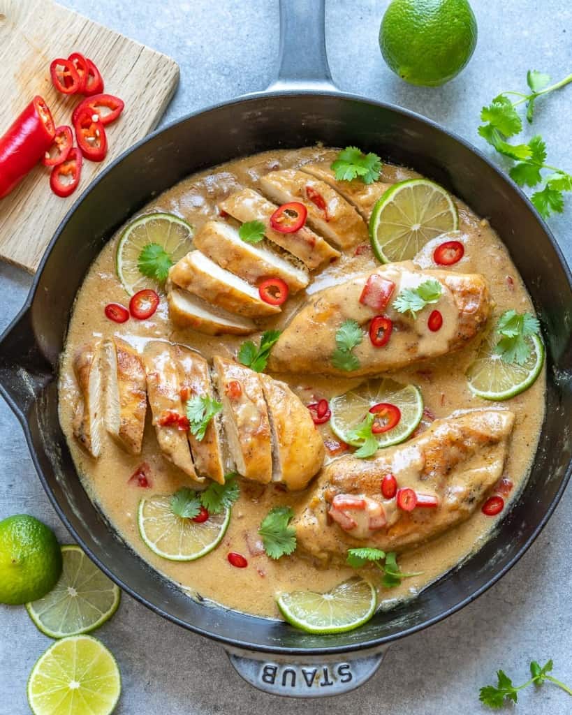 top view creamy chicken in black skillet