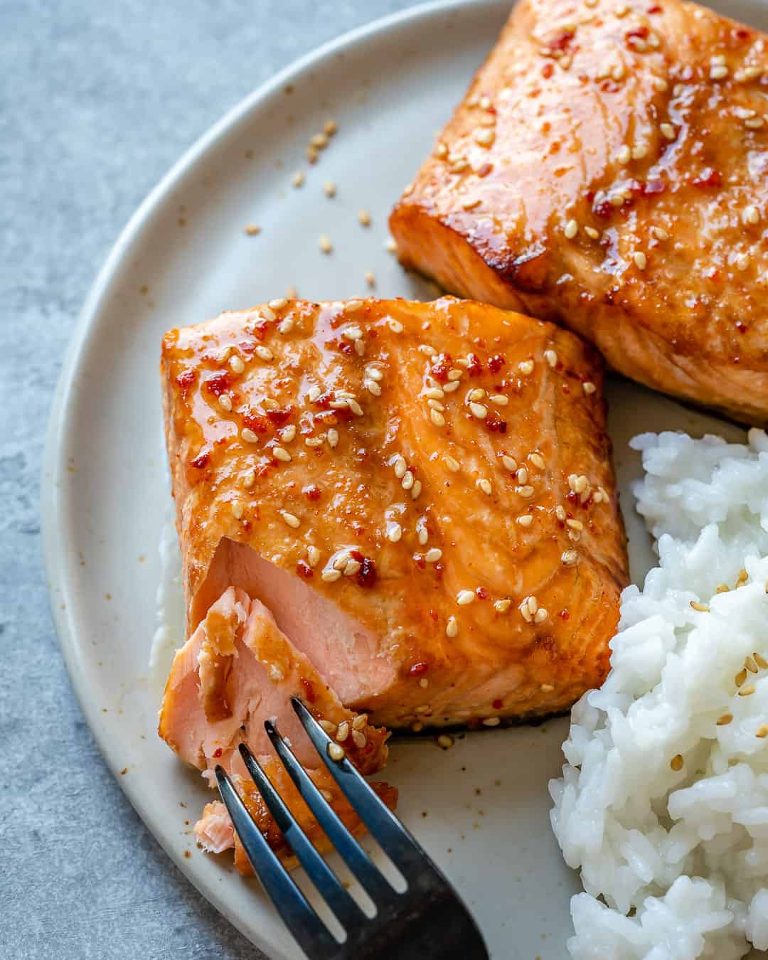 Fork with tender piece of honey glazed air fryer salmon