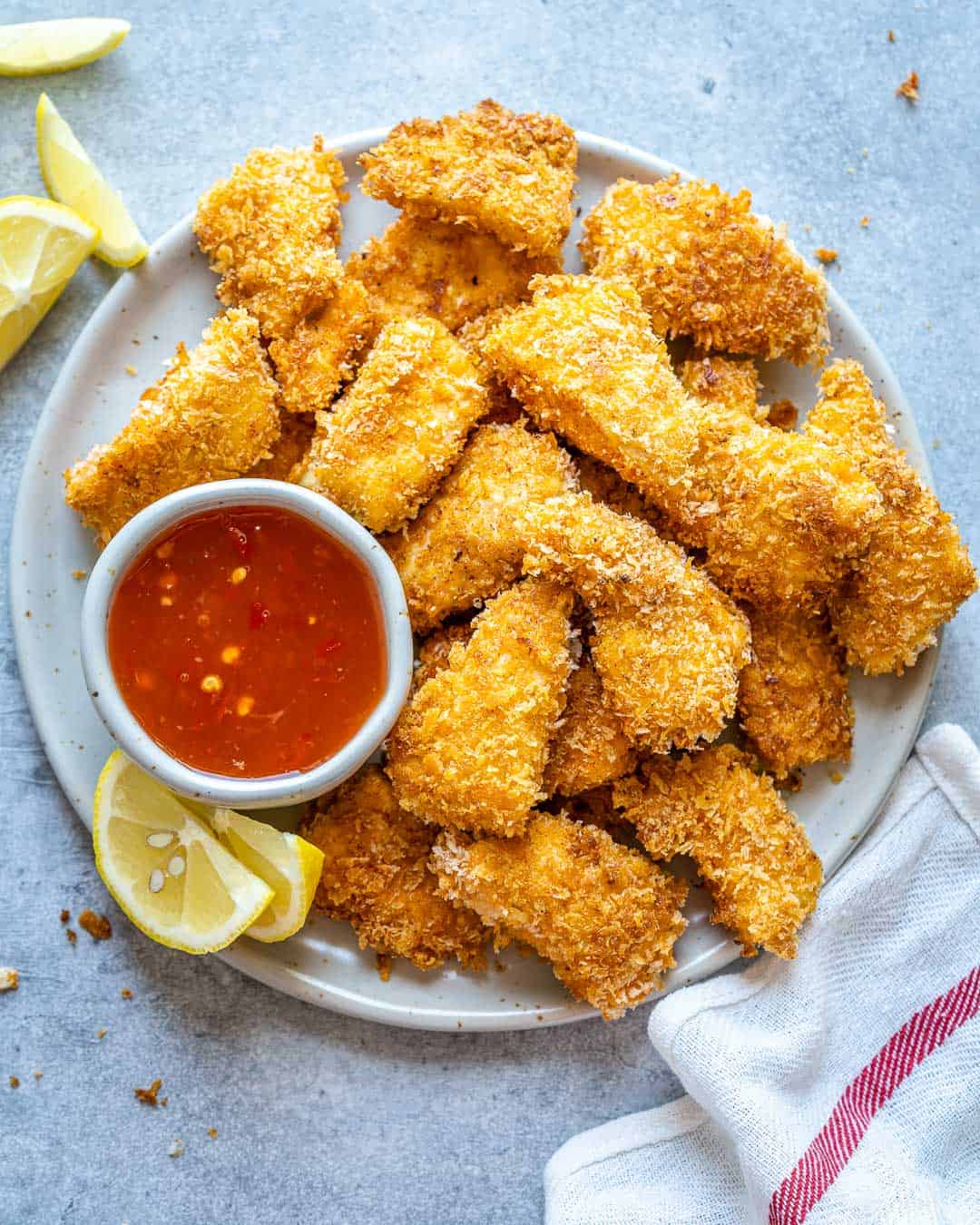 Top view of air fryer chicken nuggets with bowl of ketchup