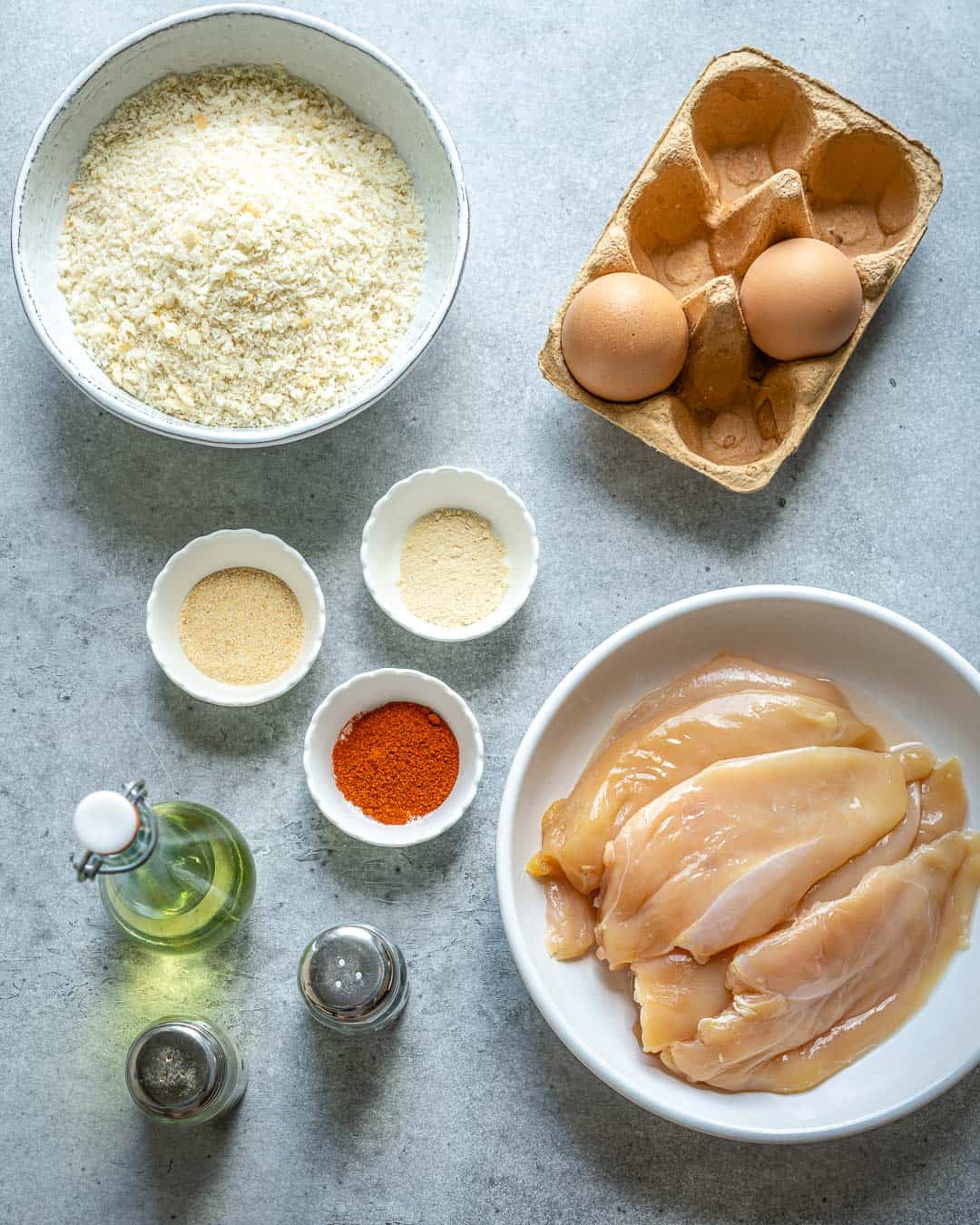 Ingredients for chicken nuggets on gray counter.