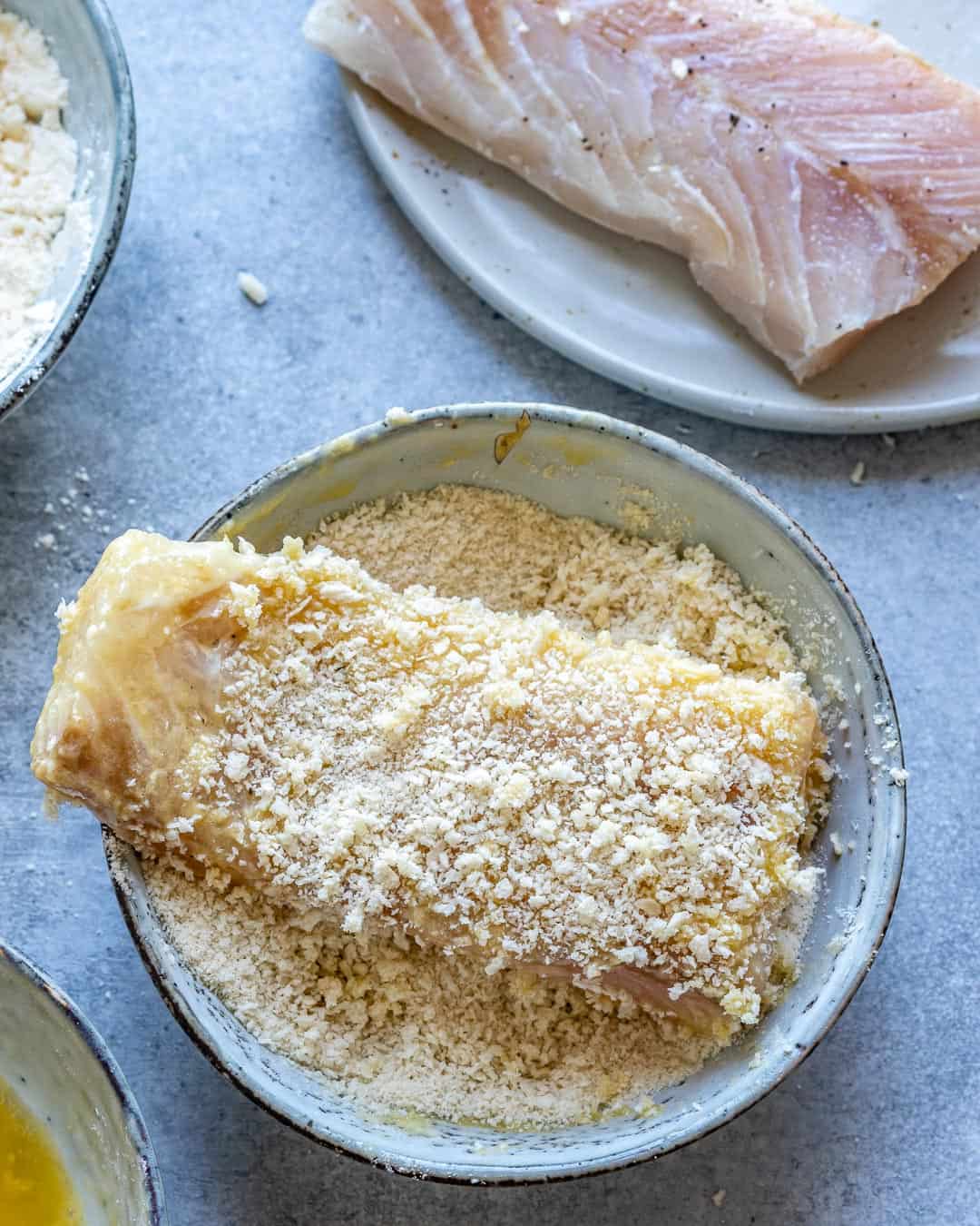 Fish filet coated in flour, egg, and breadcrumbs. 