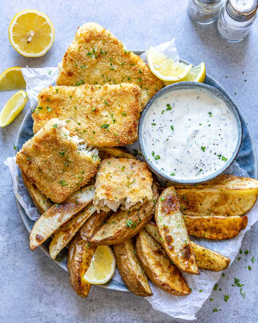 top view air fried fish with potato wedges and white dip