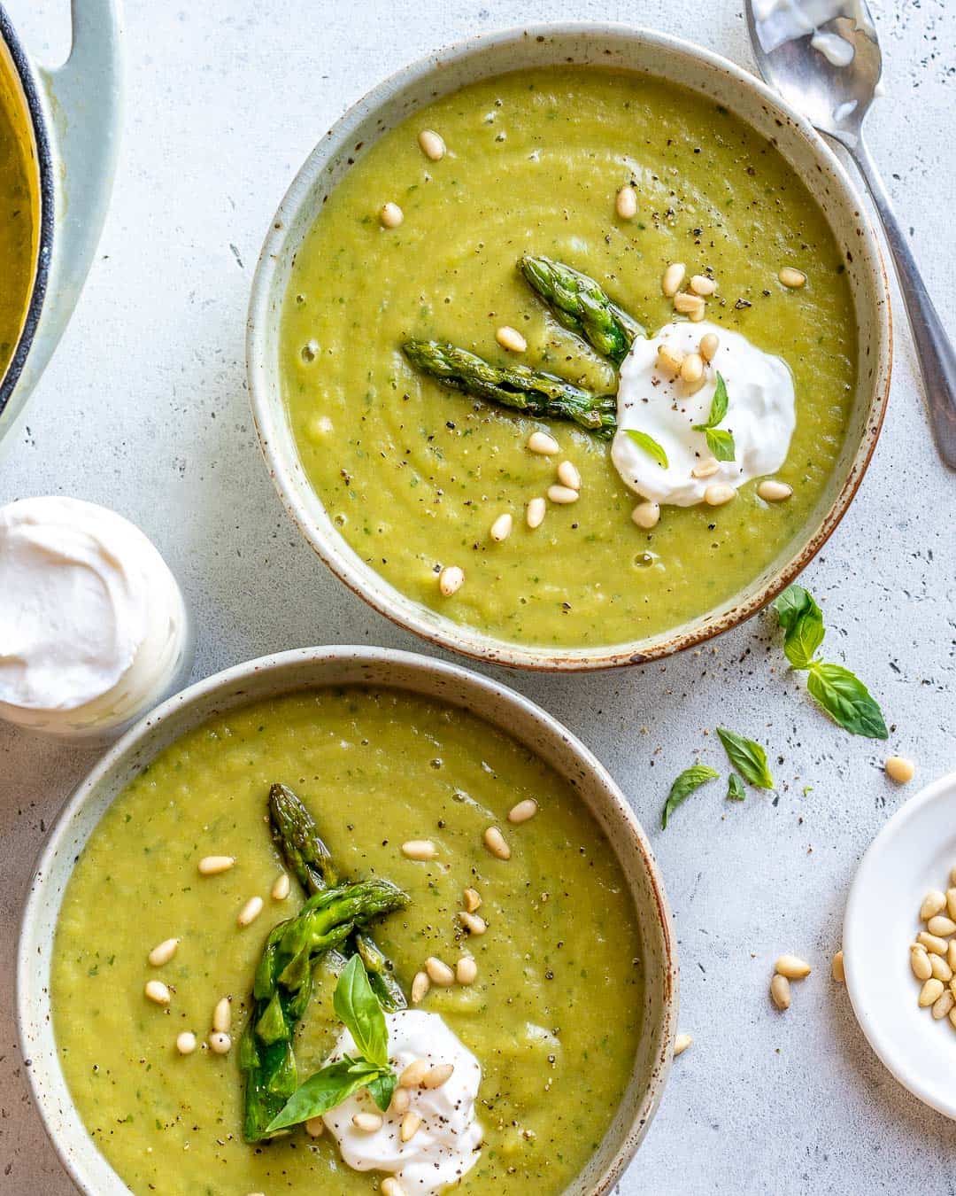 Healthy Asparagus Soup Recipe ladled into two bowls and garnished. 