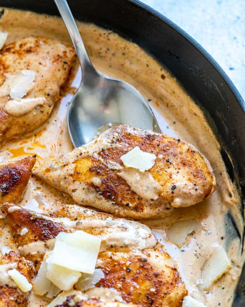 spoon lifting up a Cajun seasoned chicken breast