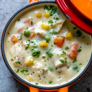 chicken pot pie soup in an orange bowl
